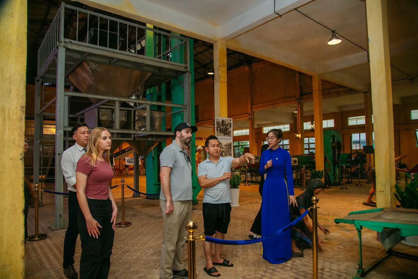Visitors learning about the 1927 Tea Factory with a guide